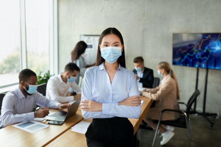 Covid-19 And Entrepreneurship. Portrait of confident young asian businesswoman in medical mask